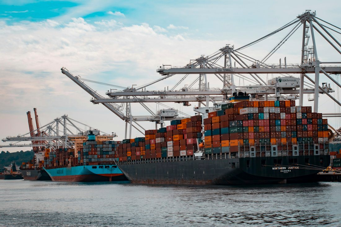 Container ship berthed under port gantry cranes